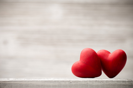 Red heart on the wooden background.